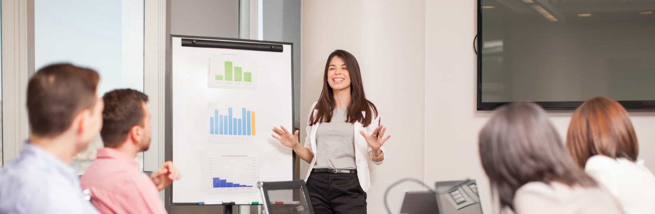 woman submitting a report to her office colleagues